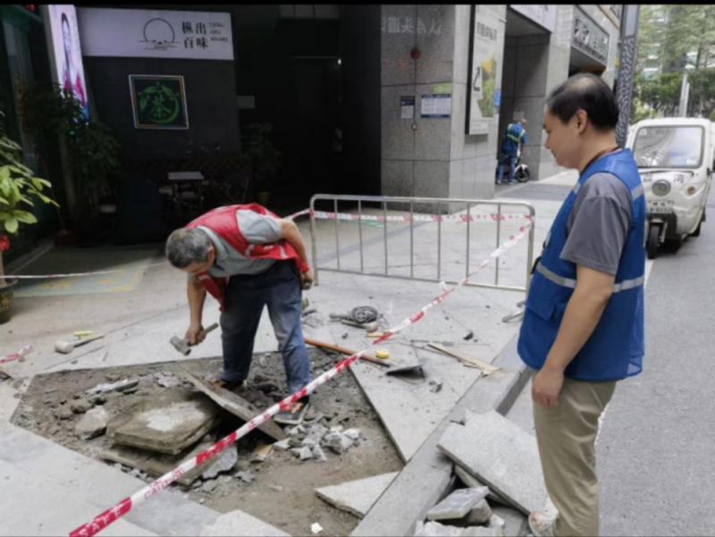 （图：网格员协助设置路障和警戒标识，提醒过往居民避让绕行）.png