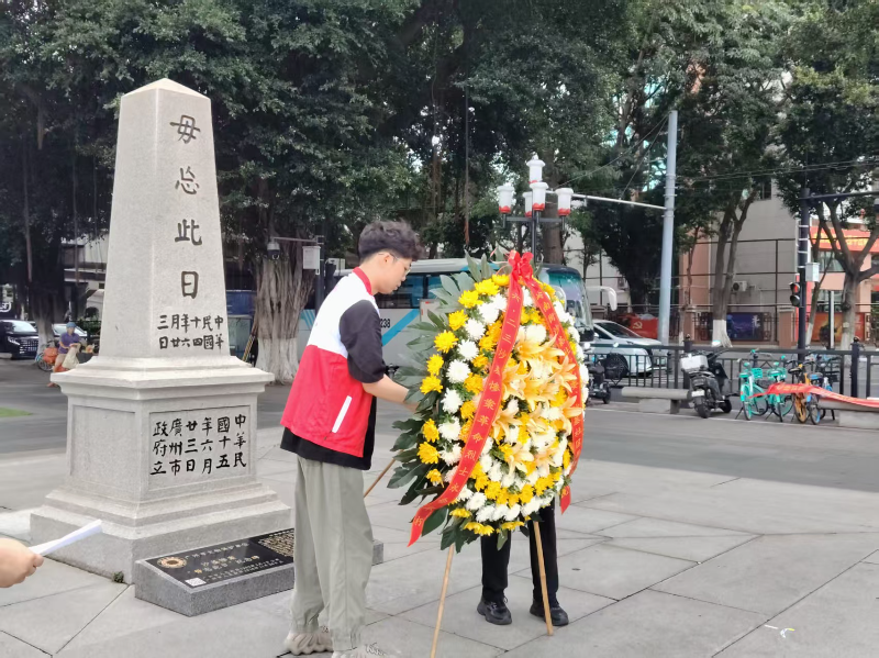 图：志愿者们向纪念碑敬献花圏.jpg